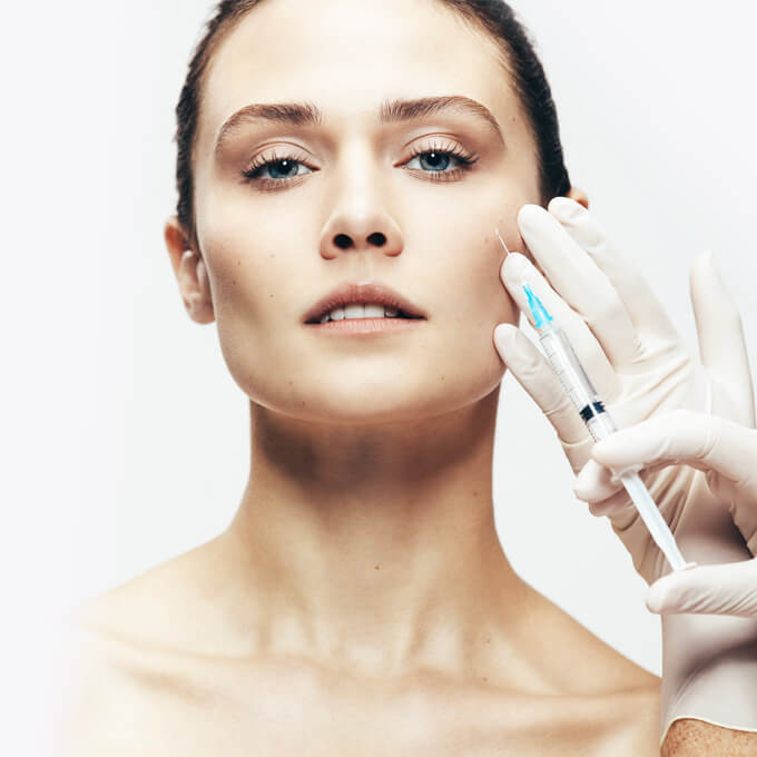 Female receiving facial aesthetic injections. 